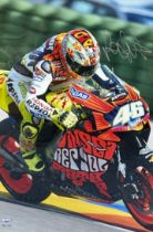 Framed Valentino Rossi signed picture. Valentino Rossi pictured on a Repsol motorbike. With chrome