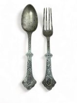 A silver Christening fork and spoon decorated with a bird (stork?) and leaf design by Thomas