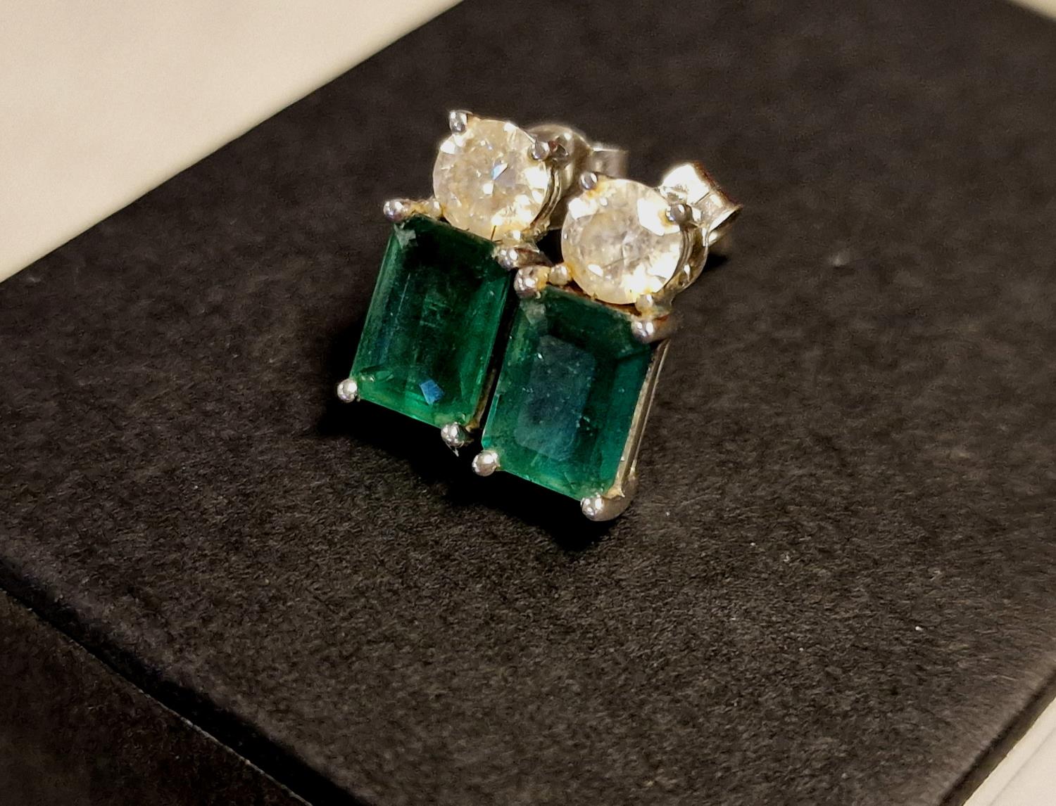 Pair of 18ct White Gold, Emerald & Diamond Stud Earrings - each set with single 1ct emerald cut ston