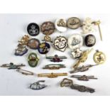 A collection of military brooches and shoulder titles etc. to include a 9ct gold bar brooch, silver,