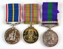 A set of three medals comprising G.S.M (1918-62), National Service and Suez Canal Medal, awarded