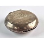 A military silver circular snuff box with hinged cover, Birmingham 1912, with match striker in edge,