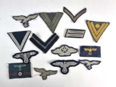 A group of German Third Reich cloth insigniacomprising a Heer Obergefreiter's rank chevron; an old-
