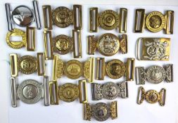 A collection of fifteen brass and white metal British Army regimental belt buckles plus two 1/2