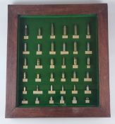 Framed display of inert ammunition cartridges, with some bullets and balls.