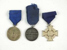 Two German Third Reich medals and one copy of an SS medal