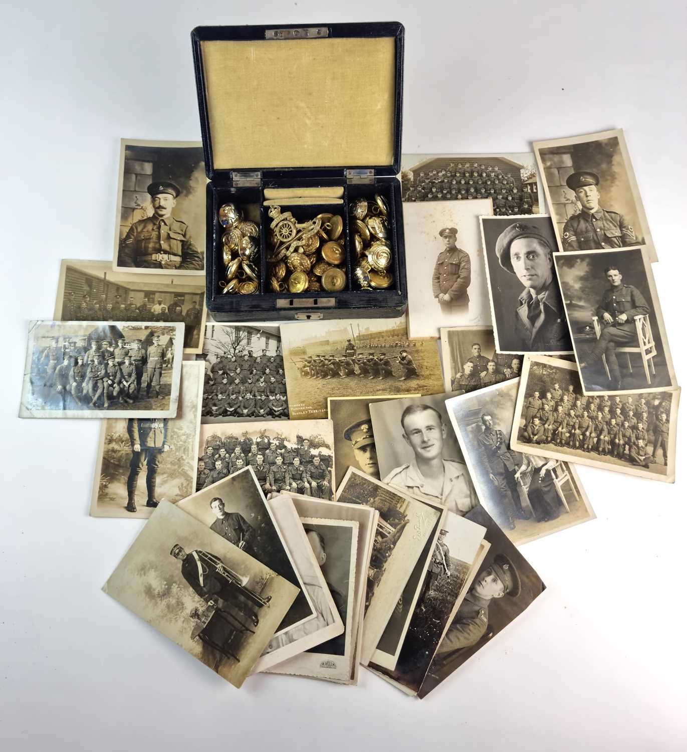 Group of British WW1/WW2 postcards and photos, together with buttons and a badge