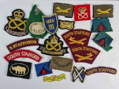 A quantity of British Army South Staffordshire Regiment military shoulder flashes and other cloth