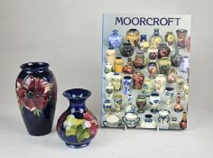 Two Moorcroft vases and a Moorcroft reference book