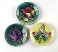 Three Moorcroft pin dishes including Arum Lily