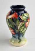 A small Moorcroft vase in the Hummingbird pattern designed by Anji Davenport