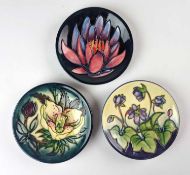 Three Moorcroft pin dishes including Hellebore