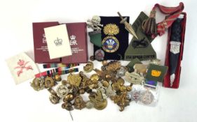 Assorted British Army cap badges, cloth badges and buttons, a reproduction Scottish dirk in box,