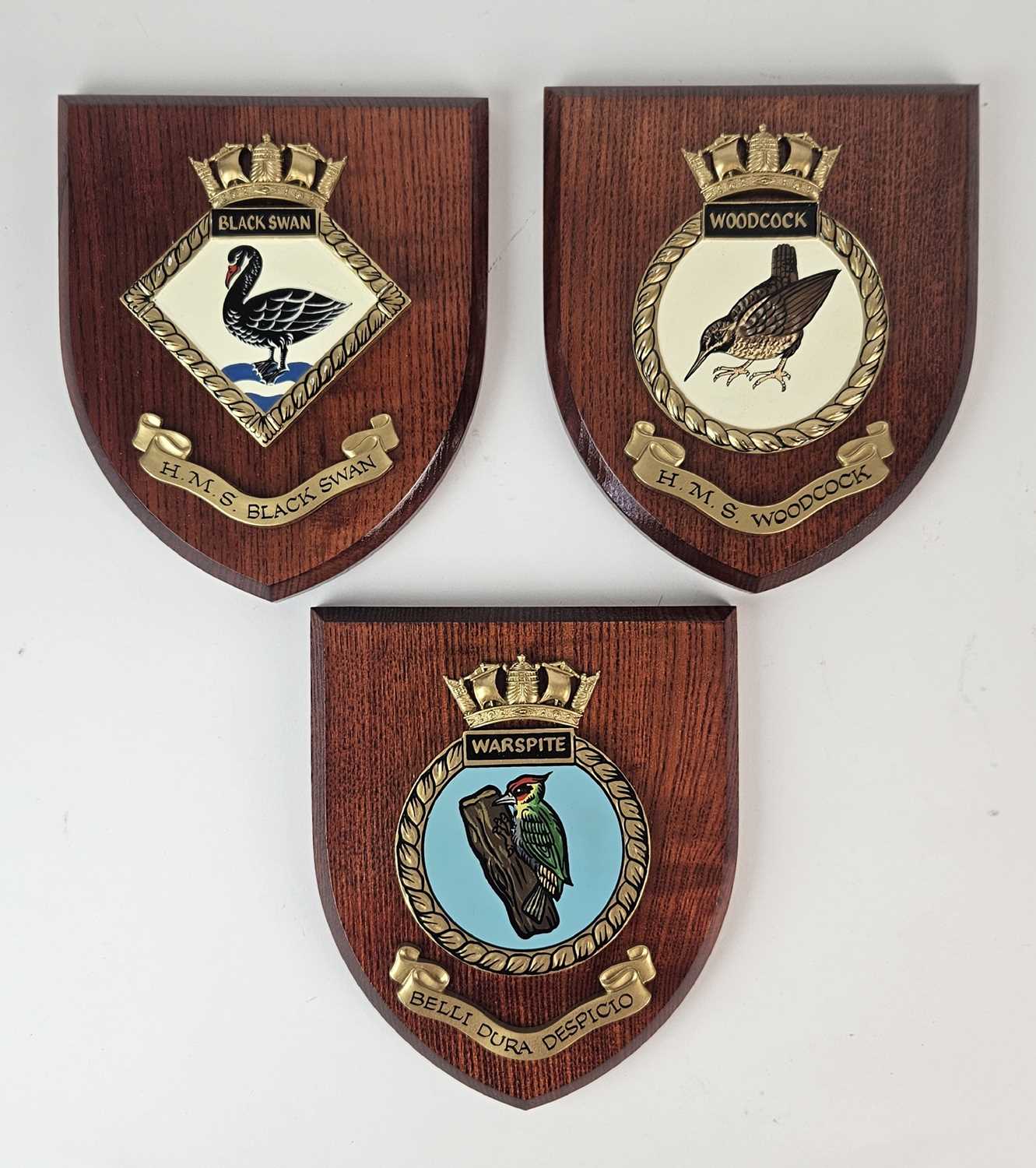 Three contemporary heraldry plaques for HMS Black Swan, HMS Woodcock and HMS Warspite, 15cm x 17cm