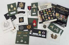 A collection of British and U.S cloth badges together with British, U.S and German cap badges and