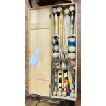 A croquet set with 8 mallets and balls in a pine case.