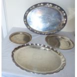 A plated oval tray cast with fruiting vine, a similar oval tray, a circular example  and a gold
