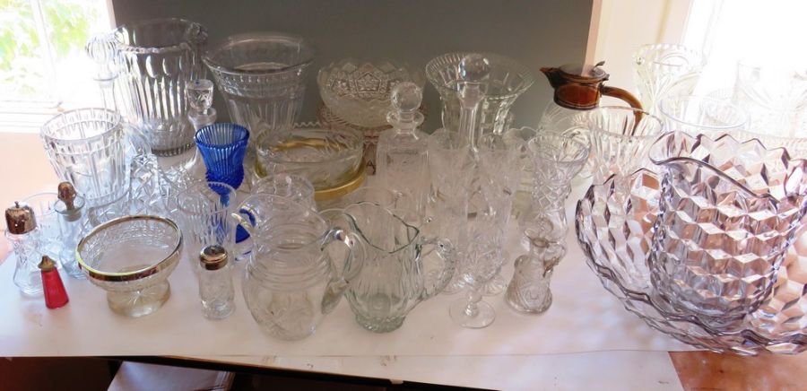 Large quantity of mixed glass wares to include a large wash jug and bowl , vases , decanters bowls