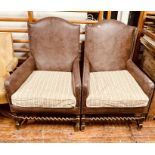 A pair of 20th century leather and brass studded armchairs, in a George III manner, arch back