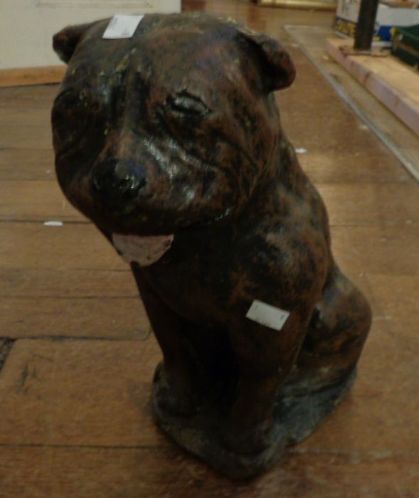 A painted, reconstituted stone dog garden statue, probably a Staffordshire terrier. Approximately 14