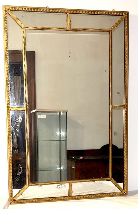 A George III and later gilt segment looking glass mirror.