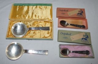 A pair of plated decorative spoons with large bowls and tapering handles, and two Swedish