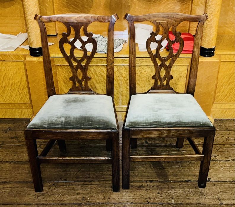 A pair of George III elm dining chairs, in a Thomas Chippendale manner, urn cresting splat,