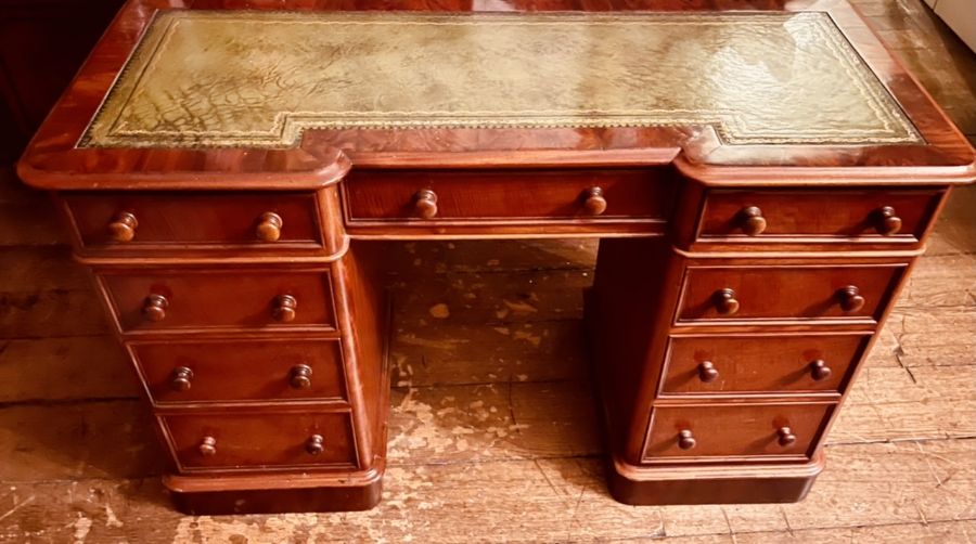 A Victorian walnut veneer twin pedestal writing desk, inverted breakfront shape, inlay leather