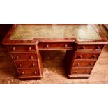 A Victorian walnut veneer twin pedestal writing desk, inverted breakfront shape, inlay leather