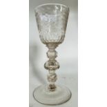 A 19th century large glass goblet, the bowl etched with flower sprays, knopped stem, spreading foot.