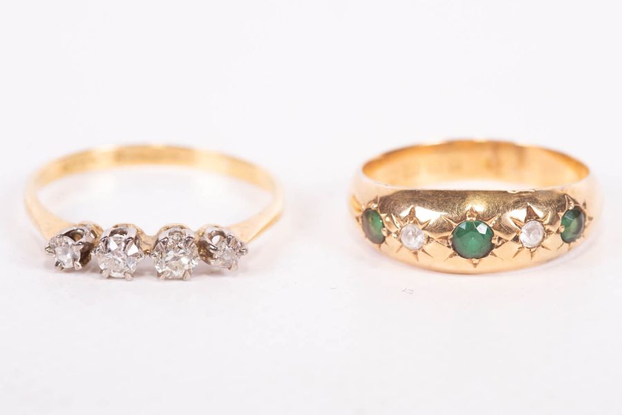 An Edwardian gypsy set 18ct gold ring featuring green and white stones, along with an early 20th