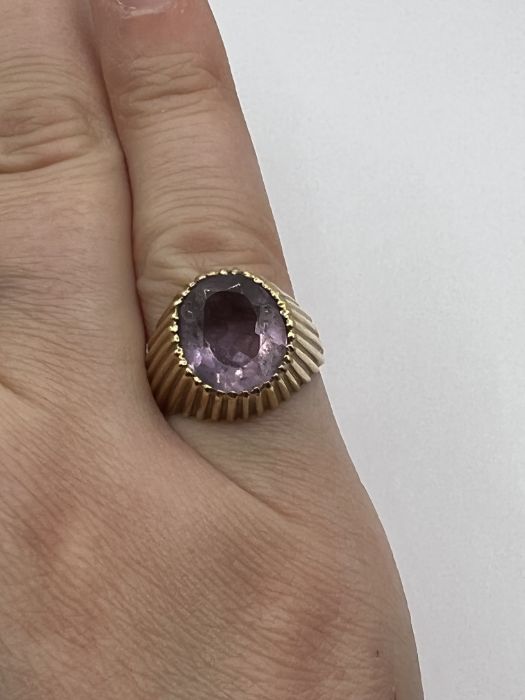 A raised setting textured Amethyst ring. Size K. Gross weight approximately 5.6 grams. (1)