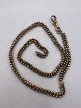 A yellow metal chevron link watch chain. Approximate weight 22.4 grams. (1)