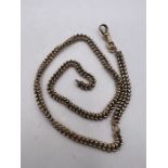 A yellow metal chevron link watch chain. Approximate weight 22.4 grams. (1)