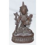 A 19th century Sino-Tibetan cast model of green Tara Buddha, 21.5cm high