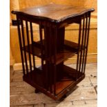 An Edwardian mahogany, marquetry strung and ivory foliage revolving bookcase, circa 1910, in
