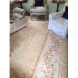 Aubusson needlepoint carpet, the central oval medallion within broad foliate swag border within