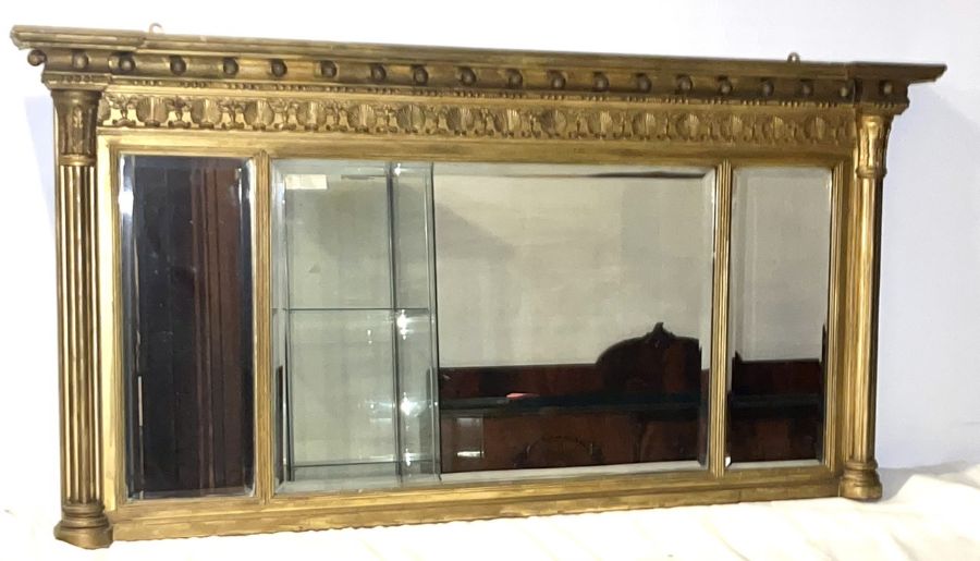 A regency and later gilt over mantle mirror.