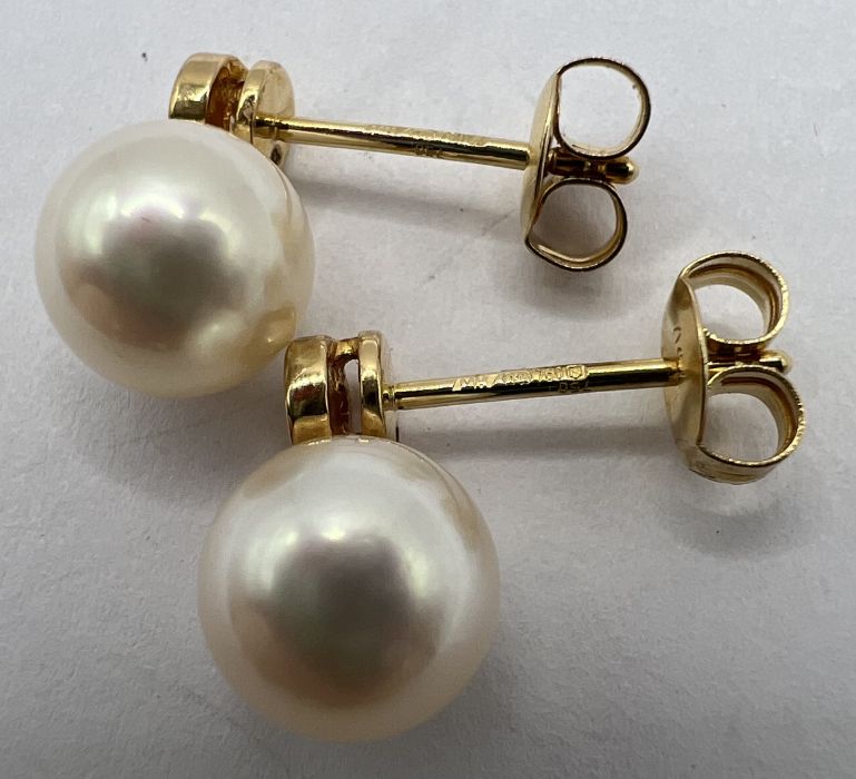 A pair of 18ct gold cultured pearl and diamond ear studs. The pearls measure approximately 8mm. - Image 2 of 3