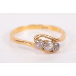 A three stone diamond set ring, in yellow metal stamped 18ct. Approximate weight 3.0 grams. Size P.