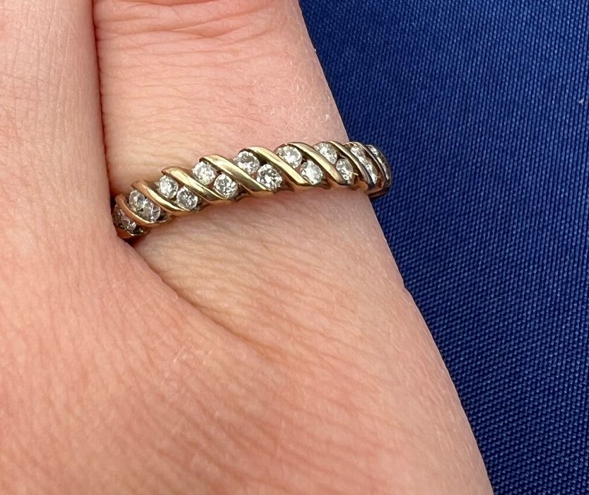 A 9ct gold diamond half hoop ring, containing 18 round brilliant cut diamonds. Total estimated