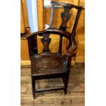 A George II elm corner chair, circa 1740, comb back top on urn shaped pierced splat, curve