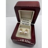 A pair of 18ct gold cultured pearl and diamond ear studs. The pearls measure approximately 8mm.