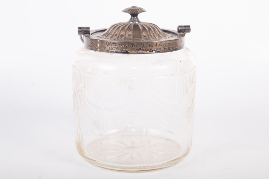 An Edwardian sterling silver lidded, cut glass, biscuit barrell. With engraved dedication to