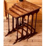 A quartetto regency revival walnut nest of tables, rectangular top on turned supports united by