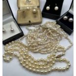 A selection of cultured pearl and 9ct gold jewellery comprising of four pairs of earrings (one as
