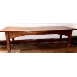 A George III oak and elm farmhouse table, three plank with cleated ends top, raised on tapered