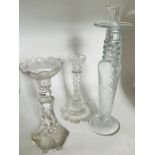 A George III style glass candlestick with facetted stem and petal base. 24.5cm high. a similar