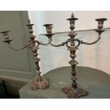 A pair of ornate silver plated three light candelabra, with removeable finnials/snuffers. The silver