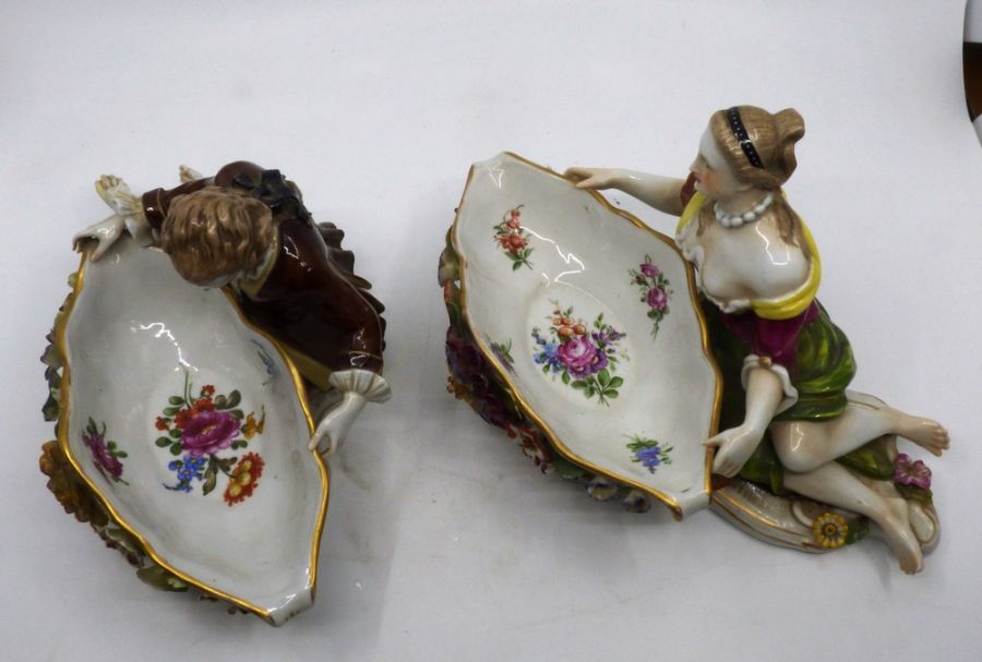 A pair of Continental porcelain figural sweetmeat dishes modelled as reclining male and female - Image 3 of 3